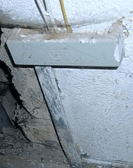 Electrical grounding (earthing) bar attached to foundation via Wikimedia Commons/O. Brill