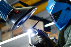 Welder using Nederman welding fume extraction equipment