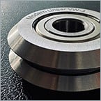 Guide rollers that clean their own track