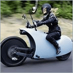 Why is electric motorcycle development behind EVs?